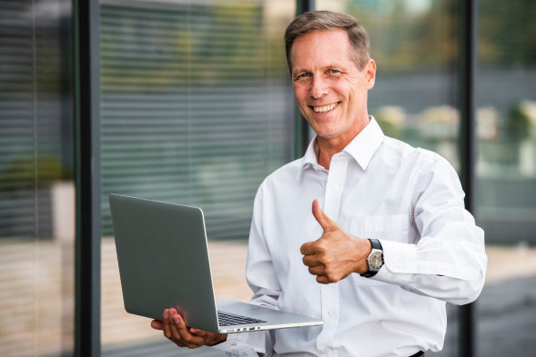 a man holding a laptop showing his professional transcription service