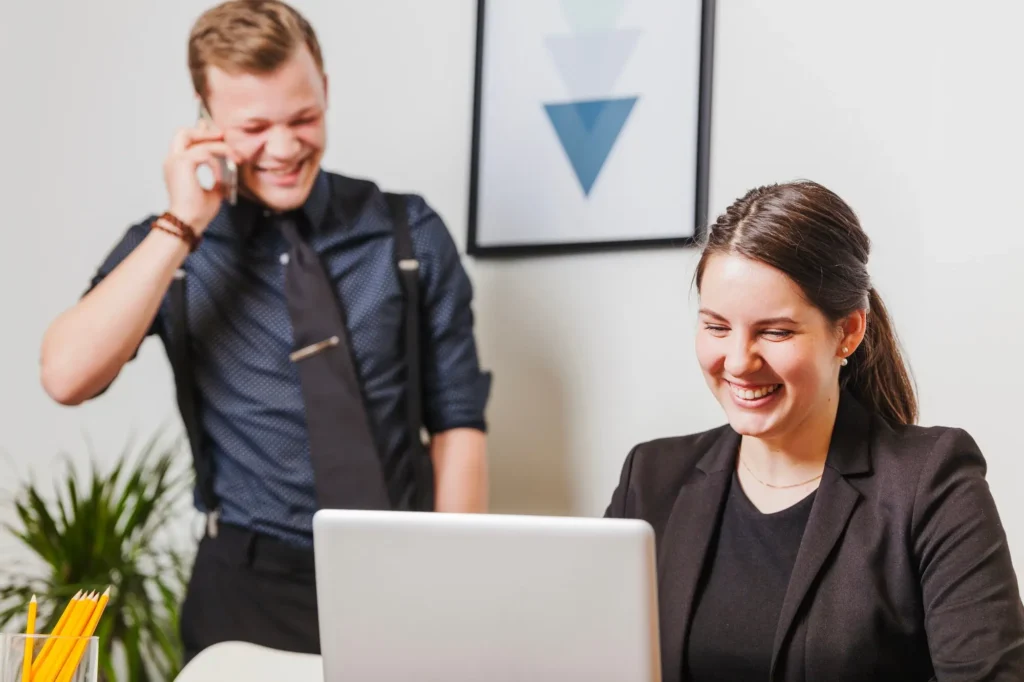 woman doing transcription services and man talking to someone